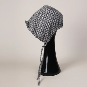 Detailed view of black and white checkered cotton headscarf with adjustable straps
