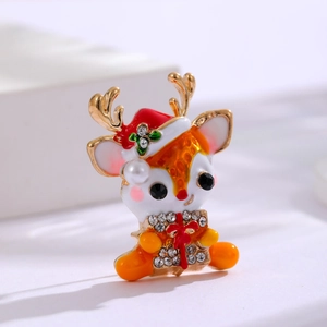 Christmas reindeer enamel brooch with gold finish, red hat and pearl details on white background