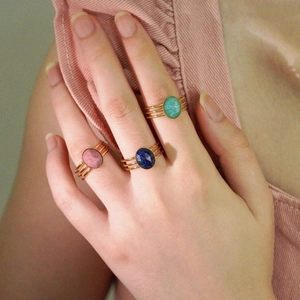 French style stainless steel rings set with colorful oval cut natural stones on a model