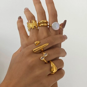 Set of five elegant gold stainless steel rings with shell, pearl, and zircon accents