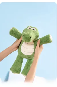 Detailed view of the soft green crocodile plush toy with cream-colored belly stripes