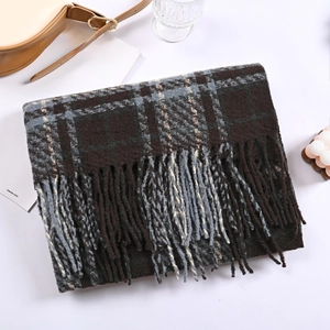 Detailed view of winter plaid scarf with fringe tassels and soft knitted texture