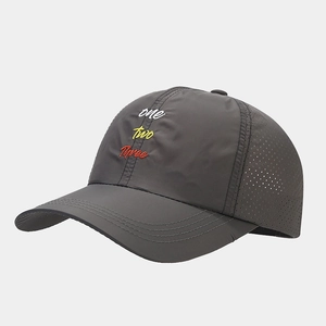 Detail of dark gray cap showing three-color embroidery and laser-cut side vents