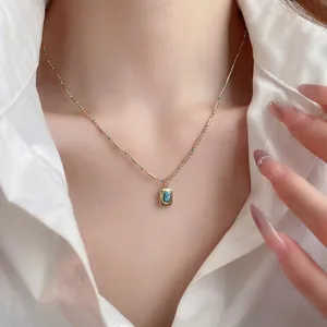 Bohemian gold necklace with turquoise beads and oval gemstone pendant on model