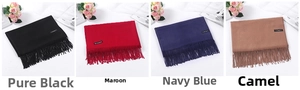 Detail showing solid color cashmere scarves in black, burgundy, navy, and camel with tassels