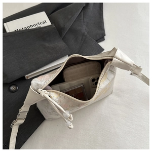 Interior view showing the capacity of a white floral jacquard bag with daily essentials