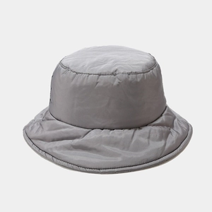 Detailed view of the thick padded texture on a dark grey winter down bucket hat