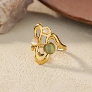 Golden wave adjustable ring with opal stones on a textured aesthetic background