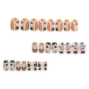 Matte cartoon press-on nail kit featuring smiley faces, rainbows, and yin-yang patterns