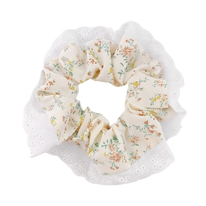 Floral fabric hair scrunchie with lace edge and orange flower print on white background