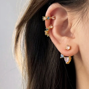 Detailed close-up of 18k gold plated stud earrings set with colorful heart-shaped zircons