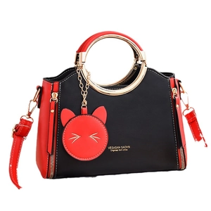 Fashionable black and red women's shoulder bag with a cute cat charm and golden hardware