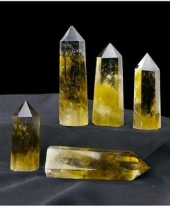 Detailed view of five natural Brazilian citrine crystal points on black background