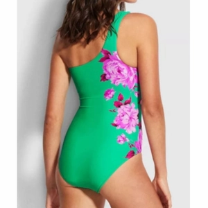 Back view of a lime green one-shoulder swimsuit featuring vibrant floral patterns