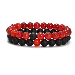 Macro shot of 8mm elastic bracelets with polished red beads and matte black stones