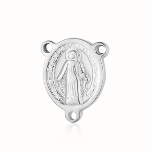 Detail of silver religious medal showing embossed Virgin Mary with holy prayer engraving