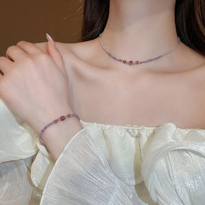 Detail of purple amethyst beaded necklace and bracelet set on female model's neck and wrist