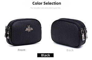 Detail of black pebbled leather coin purse with double zippers and silver bee hardware