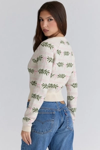 Detail of slim-fit knit sweater with pine needle and pink bow jacquard patterns
