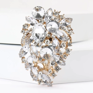 Detailed macro view of gold alloy brooch with intricate crystal and rhinestone settings