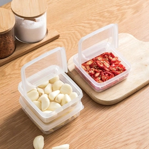 Square clear food storage box with lid for fresh garlic and chili in a kitchen setting
