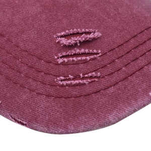 Detail of distressed vintage baseball cap with washed denim texture and frayed edges