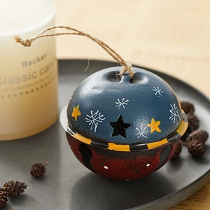 Retro metal Christmas bell with star cutouts and hemp rope hanging on vintage background