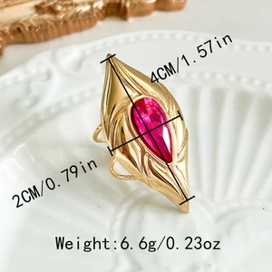 Gold-plated stainless steel teardrop ring with pink zircon on ceramic tray, 4cm length
