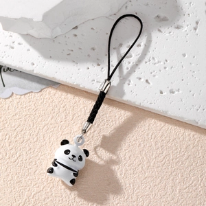 Close-up of cute panda phone charm with black woven lanyard and silver metal buckle