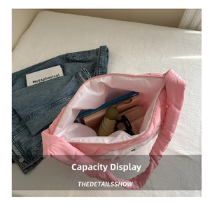 Large pink quilted tote bag interior showing ample space for books, umbrella and wallet