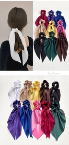 Detail of satin scrunchies with long ribbons showing silky texture in various colors