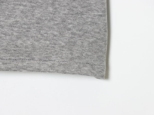 Detail shot of the precise edge stitching and grey knit texture on the two-piece dress set