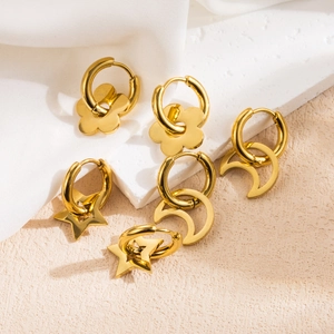 Gold stainless steel hoop earrings set with flower, star and moon charms in minimalist style