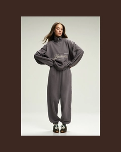 Detail of taupe half-zip sweatshirt and matching joggers set with embroidery