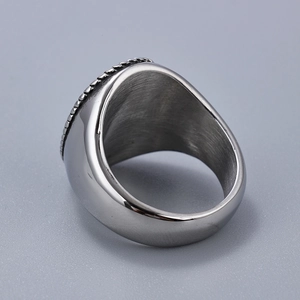 Macro shot of silver stainless steel ring featuring brushed texture and polished edges