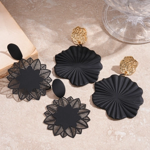 Gothic black geometric flower earrings with intricate cutouts and golden textured studs