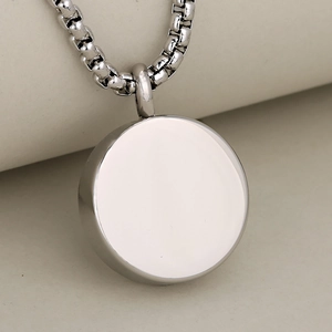 Polished silver stainless steel round paw print cremation urn necklace for pet memorial