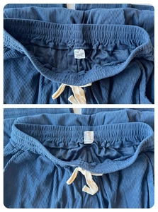 Detailed view of elastic waistband with cream drawstring on blue corduroy pants