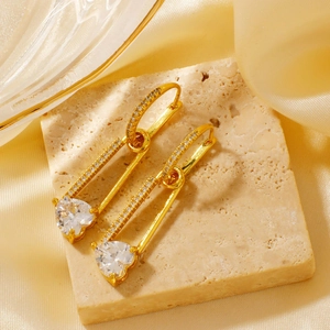 Luxury gold heart safety pin earrings with sparkling zircon stones in a warm aesthetic