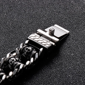 Detail of vintage braided leather bracelet featuring a steel skull charm and buckle