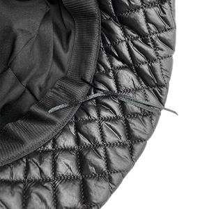 Detail of black quilted bucket hat inner adjustable drawstring and ribbed sweatband