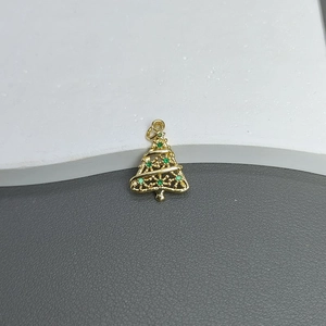 Detailed view of a gold Christmas tree pendant with green zircon micro-inlay stones