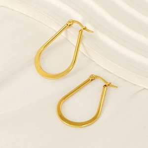 Minimalist U-shaped gold stainless steel earrings with a polished finish on white surface