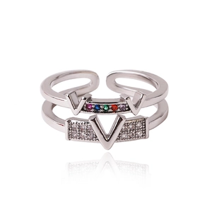 Detailed macro shot of silver double-layer V-shaped ring with colorful zircon gemstones