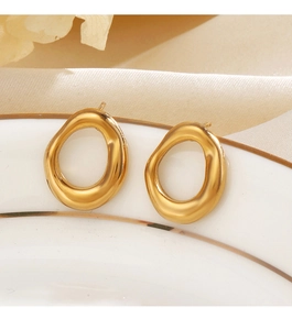 Detail of minimalist 18K gold plated organic round earrings on elegant ceramic tray