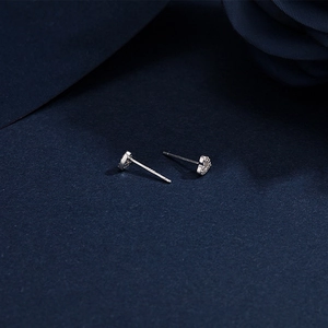 Macro shot of S999 sterling silver heart stud earrings with shiny pavé cubic zirconia