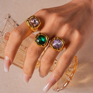 Macro view of vintage gold rings with square pink green and purple gemstones