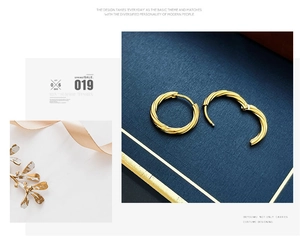 Detailed view of elegant gold twist hoop earrings on a luxury minimalist background