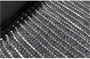Detailed macro view of sparkling silver rhinestone fringe on premium black fabric material