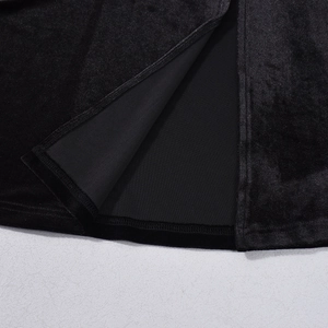 Detail of black velvet slit hem showing professional stitching and layered fabric texture